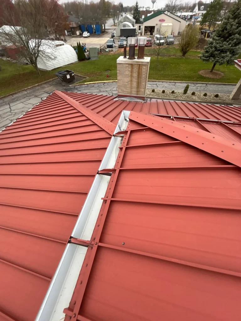 Nitro Roofing red metal roof seam repair in Wapakoneta, Ohio